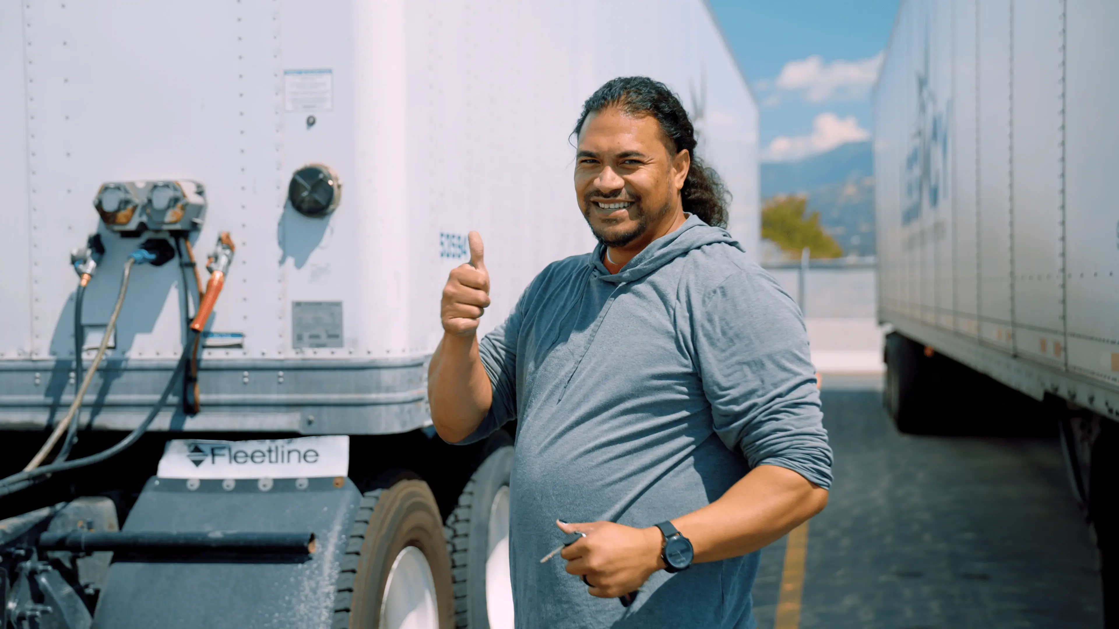 Professional CDL driver smiling in the cab